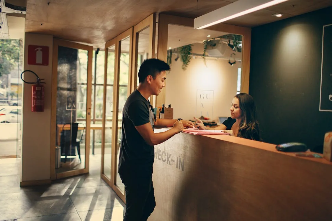 A guest checking in at a hotel front desk